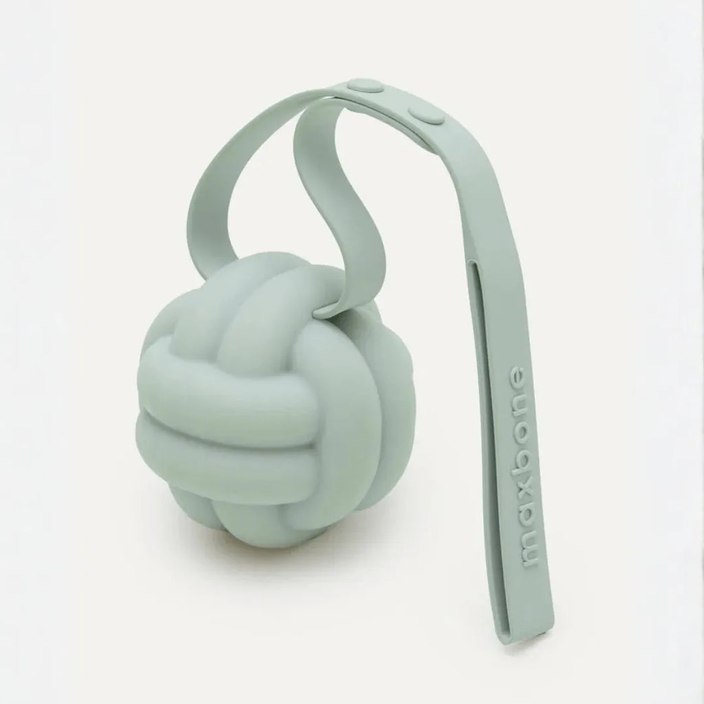 Sage green silicone knot ball dog toy on looped tether strap with maxbone logo