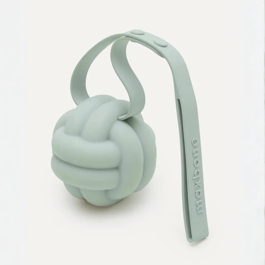 Sage green silicone knot ball dog toy on looped tether strap with maxbone logo