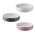 Three ceramic cat saucer bowls in white, grey and pink with embossed fish and paw design, Mason Cash