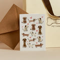 White greeting card with illustrated dogs and hearts, kraft envelope and Pet Hamper gift bag