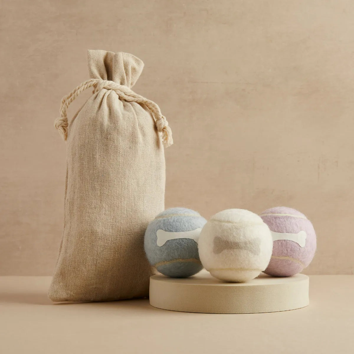 Three tennis balls in blue, cream and lavender with bone design and linen bag, Pet Hamper