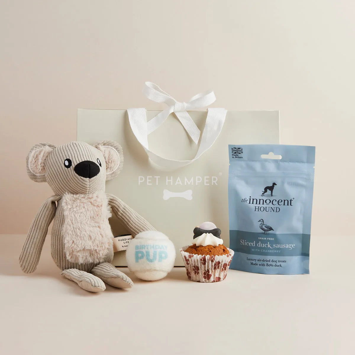 Birthday Boy dog hamper with plush koala toy, tennis ball, cupcake toy, duck sausage treats and gift bag