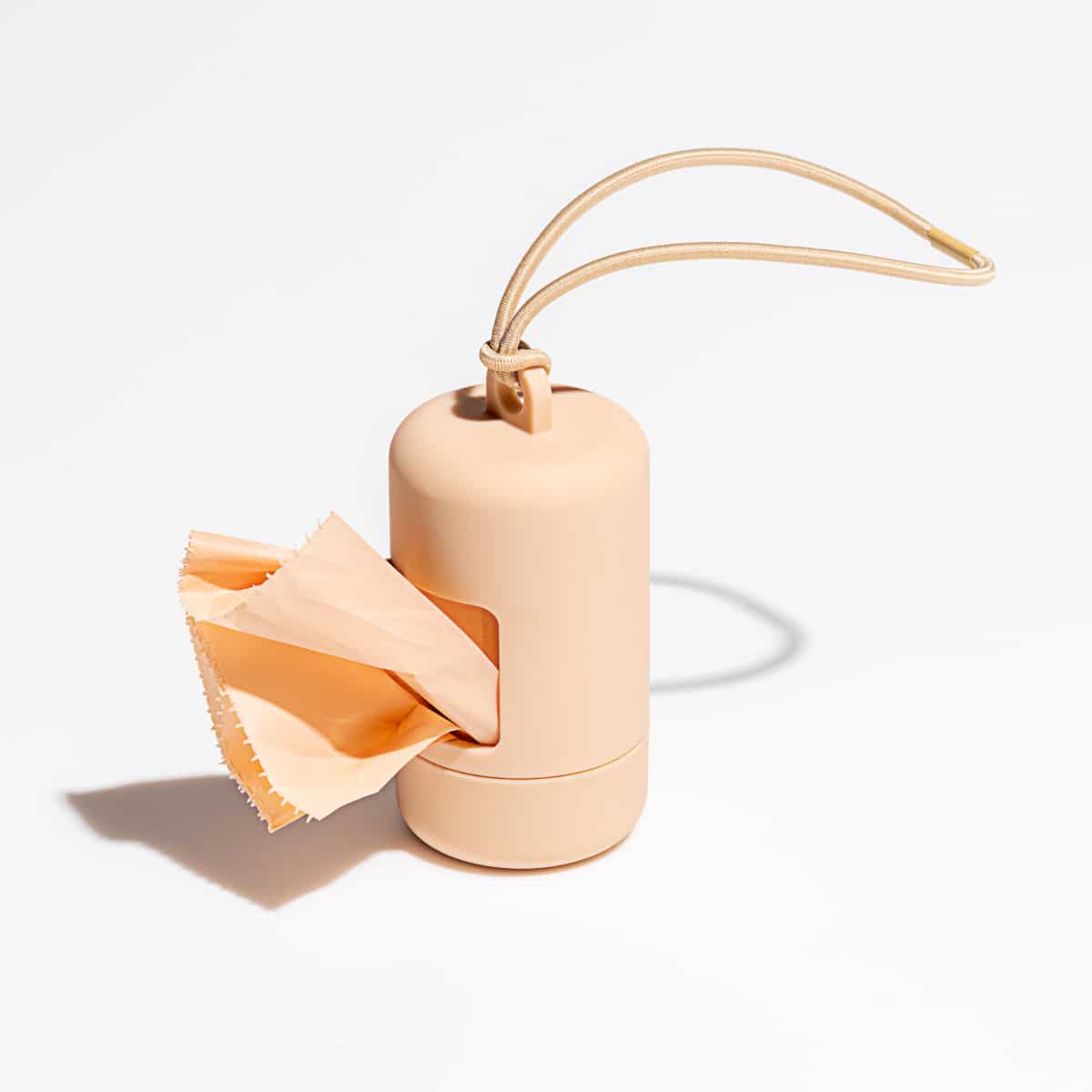 Tan poop bag holder with cord loop and bag dispensing, Wild One