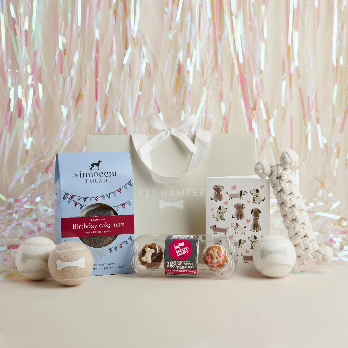 Pawty Time dog birthday hamper with cake mix, tennis balls, cupcakes, rope bone, greeting card and gift bag, tinsel backdrop