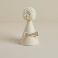 Cream dog party hat with wool pom-pom and bone decoration