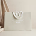 Beige Pet Hamper branded gift bag with white ribbon bow, Small Animal Hamper banner