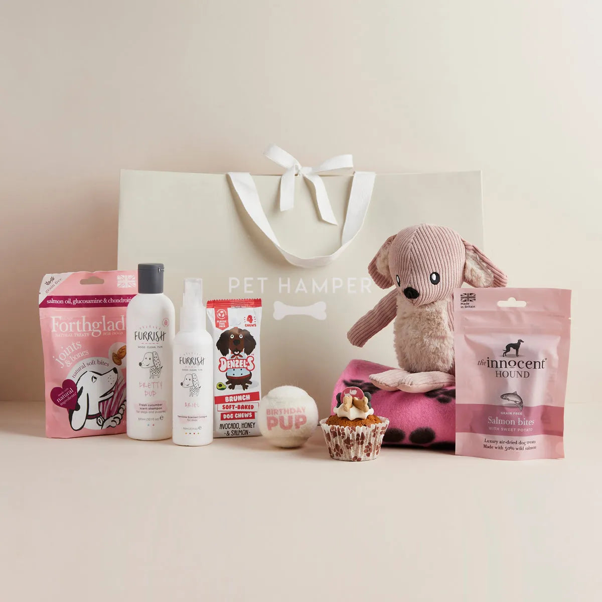 Lux Birthday Girl dog hamper with plush pink dog toy, shampoo, dental treats, cupcake toy, blanket, tennis ball, salmon treats and gift bag