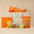 Sainsbury's Money Dog Hamper with orange lickmat, turkey treats, peanut butter jar, cod skin strips, tennis ball and gift bag