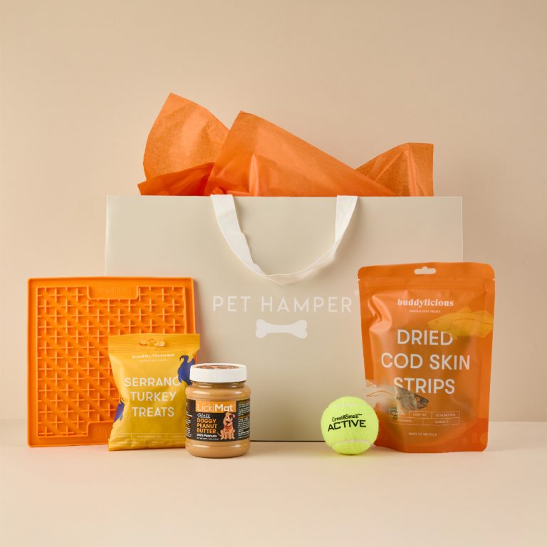 Sainsbury's Money Dog Hamper with orange lickmat, turkey treats, peanut butter jar, cod skin strips, tennis ball and gift bag